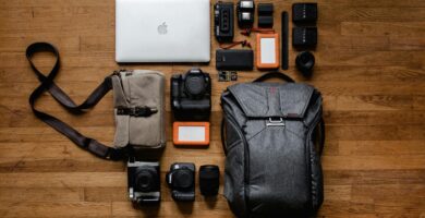Smartphones, cameras, bags and laptop on top of a wooden table as the best gadgets 2026