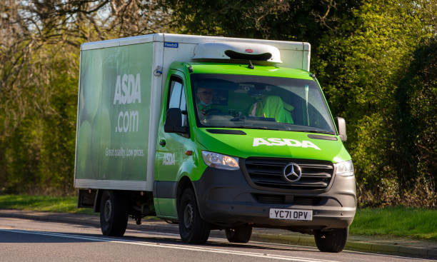 Asda electric delivery van providing home grocery service in a UK residential area.