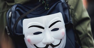 kid wearing a backpack with horror smiley mask