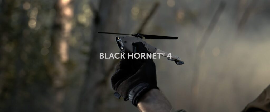 Black hornet 4 military uav drone taking a flight in the woods