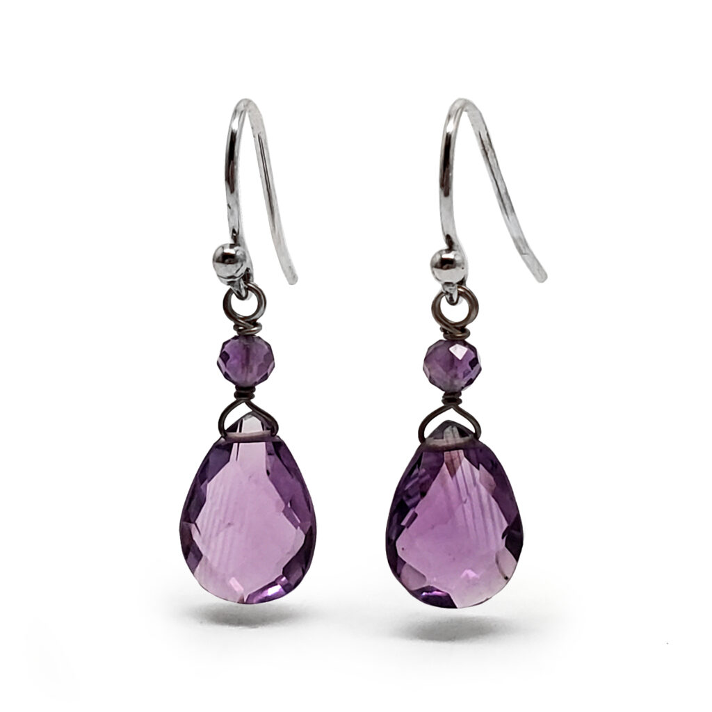 Intense purple amethyst jewelry drop earrings set in polished silver frames.
