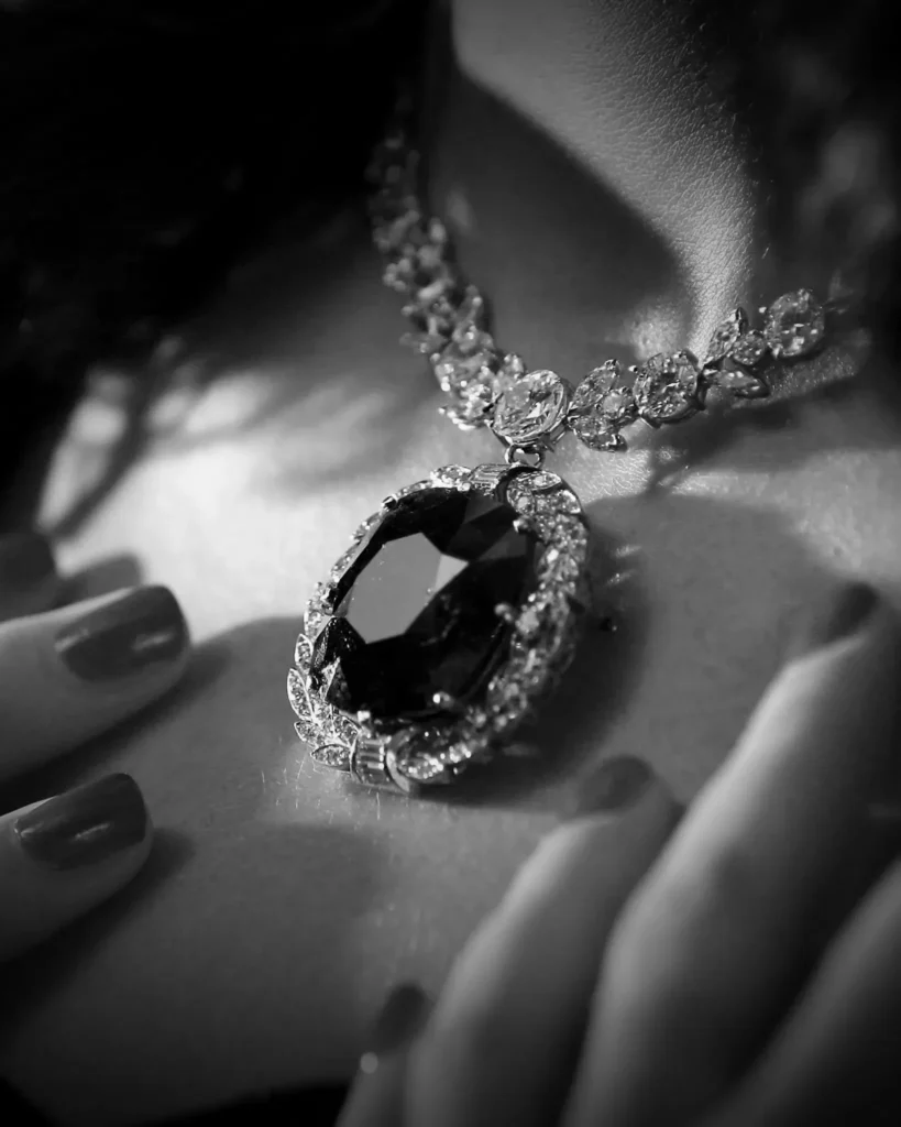 Close-up of a faceted black diamond necklace featuring a sleek adamantine luster