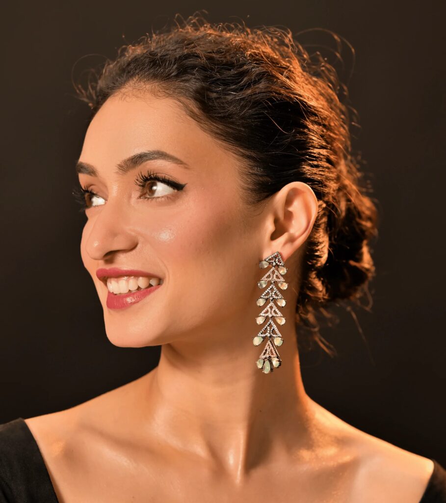 Delicate Model wearing brilliant-cut diamond stud earrings reflecting light, symbolizing luxury and permanence.