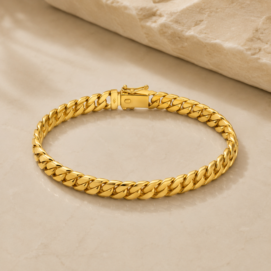 Solid 14K Gold Bracelet with polished yellow gold links on a luxury marble surface